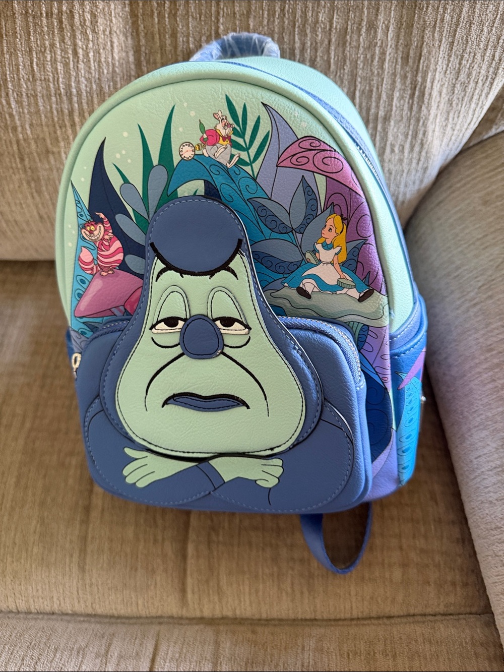 Disney lounge fly Alyse in Wonderland featuring the caterpillar backpack
